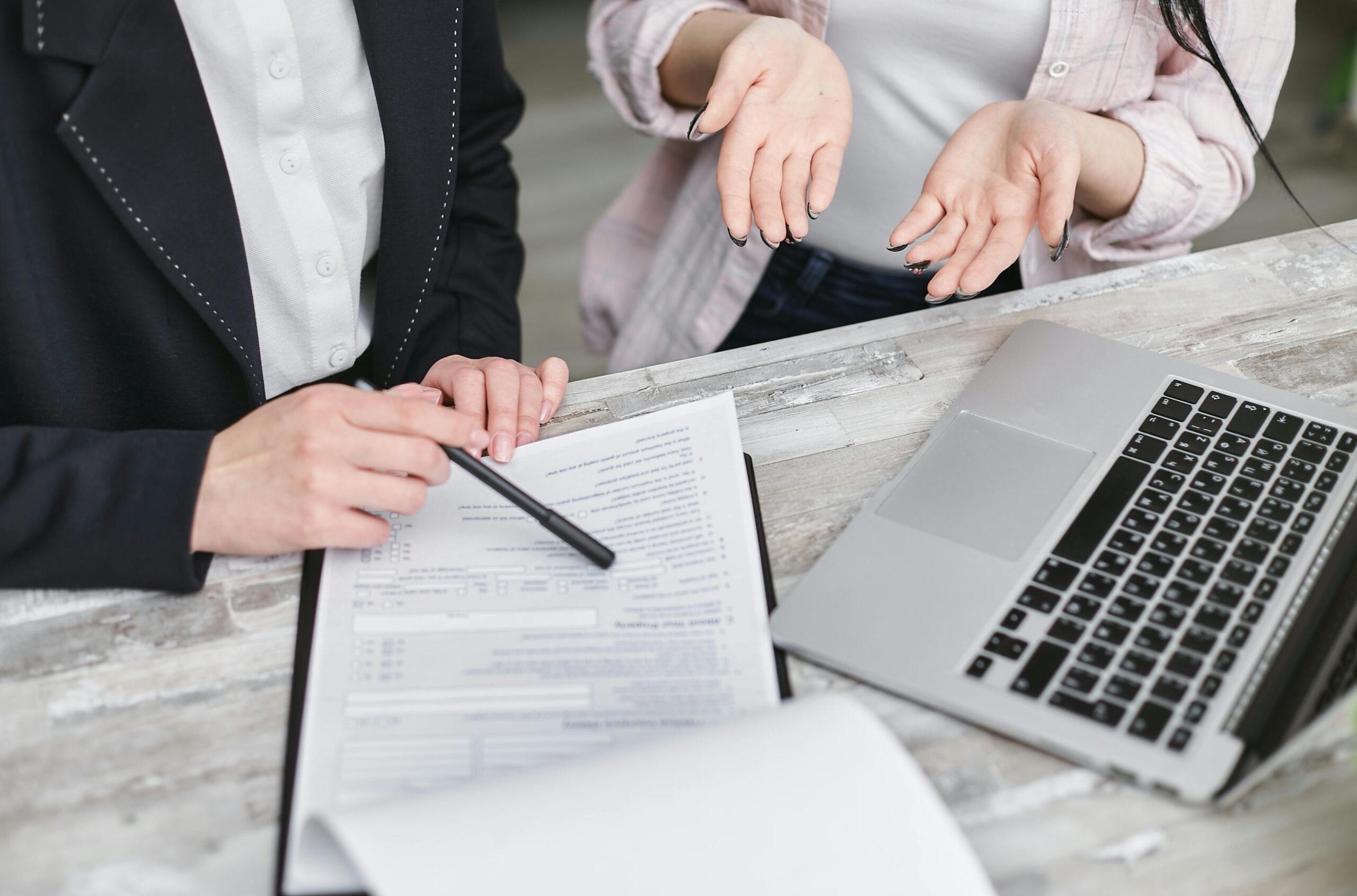 two people working at a laptop